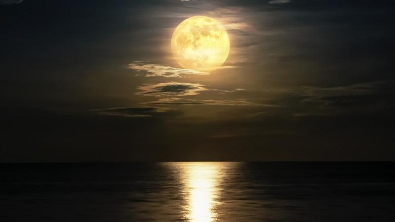 A full moon over water. 