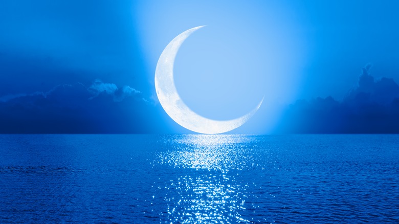 A crescent moon over water 
