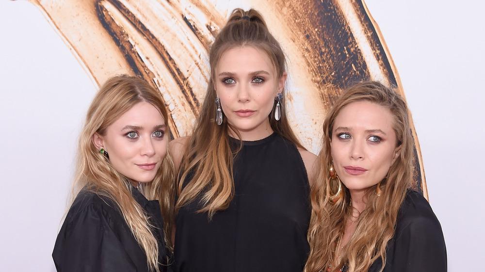 The Olsen twins posing with Elizabeth