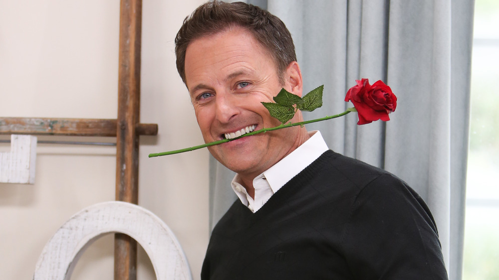 Chris Harrison with rose in mouth