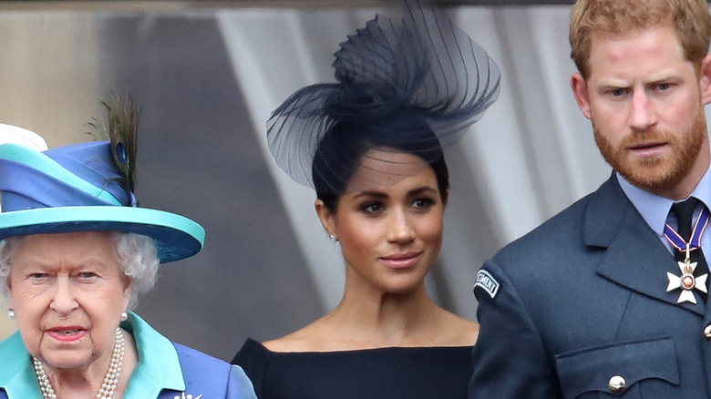 Prince Harry with Queen Elizabeth and Meghan Markle