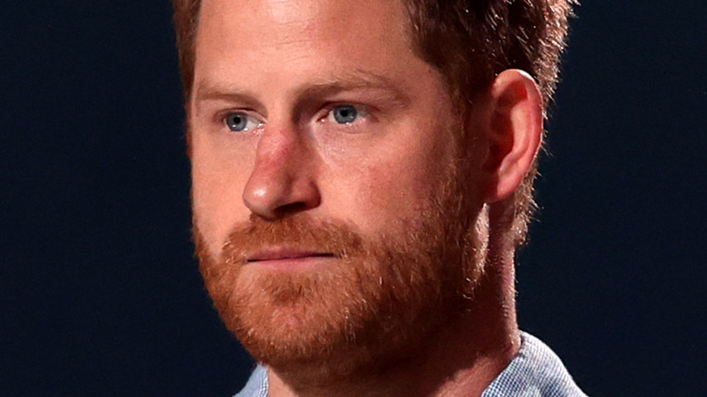 Prince Harry looking serious with facial hair