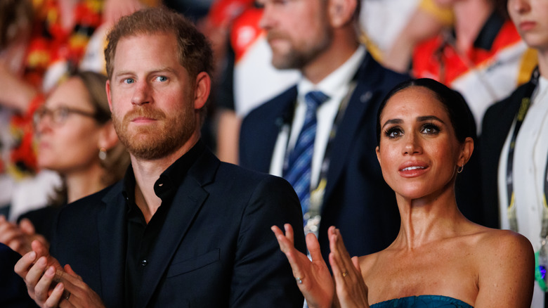 Prince Harry and Meghan Markle clapping