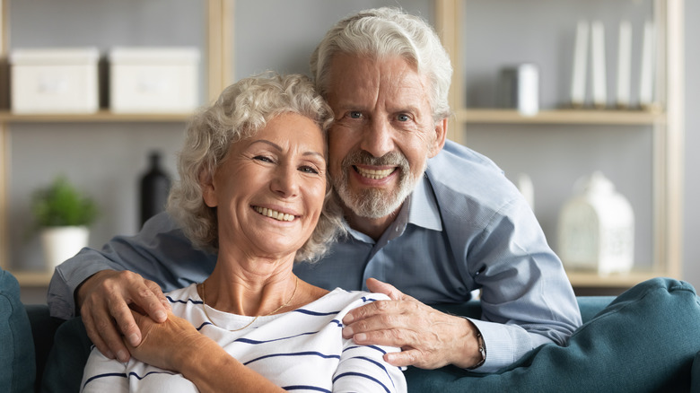 A happy couple posing for a photo. 