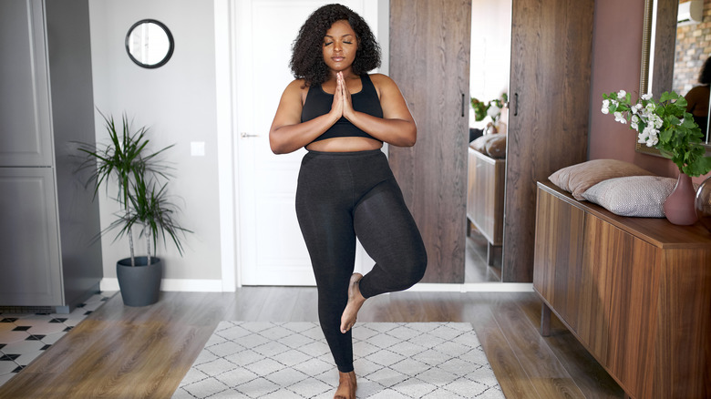 A woman practicing yoga.