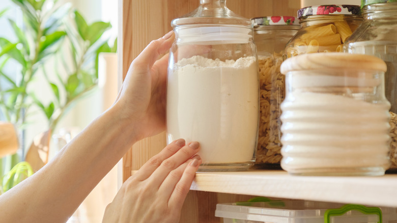 Woman reaching for pantry items