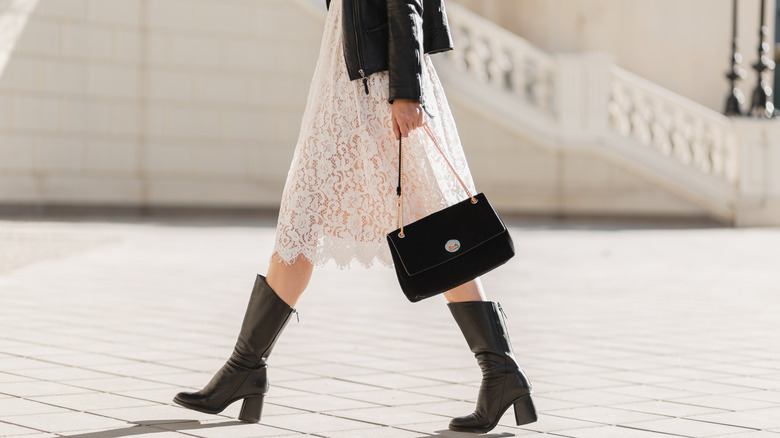 woman in lace dress and leather boots