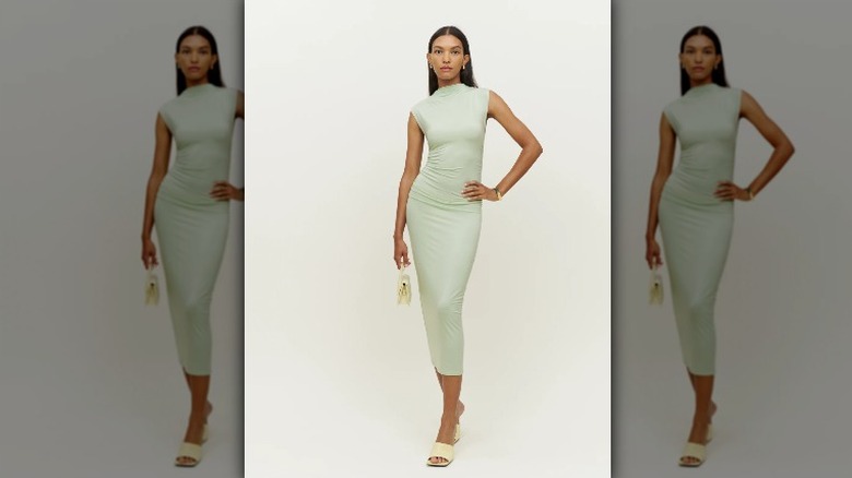 Reformation model wears green midi