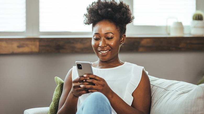 Woman looking at phone and smiling