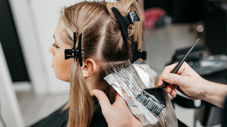 woman dying hair at salon