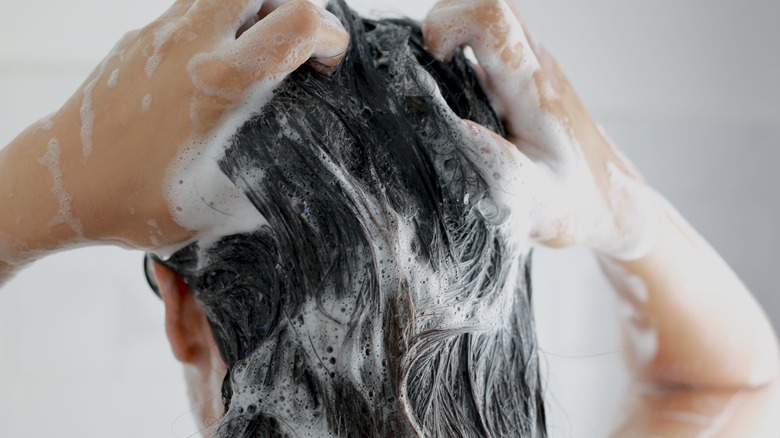 woman shampooing her hair shower