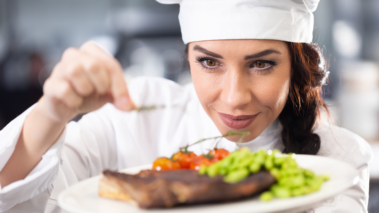 Gourmet chef garnishing a dish