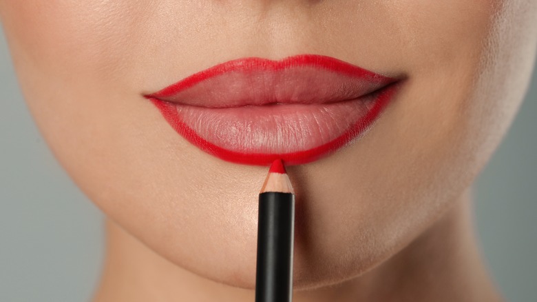 Woman using a red lipliner