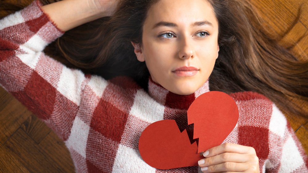 Woman holding broken heart