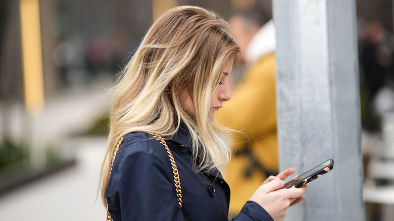 Woman texting outside