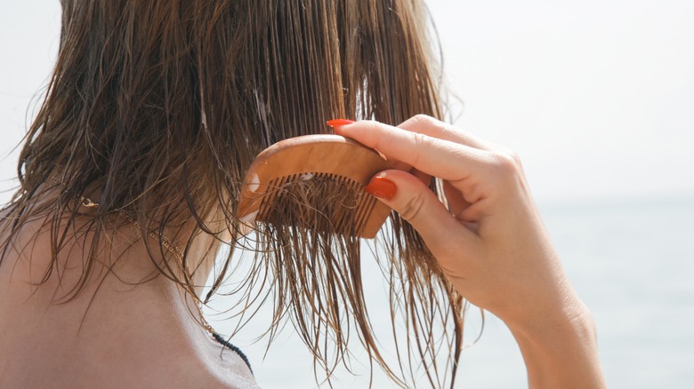 beautiful woman brushing wet hair