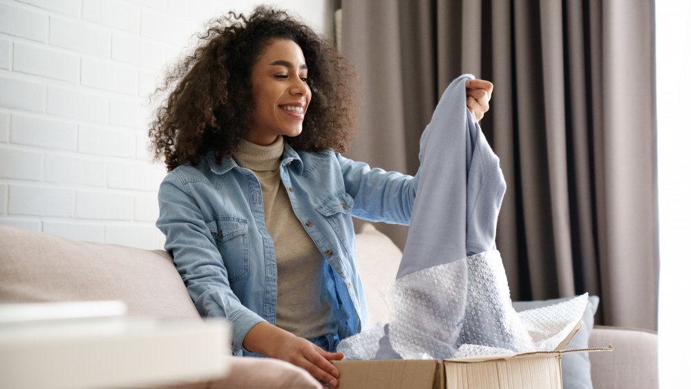 Woman unwrapping clothing