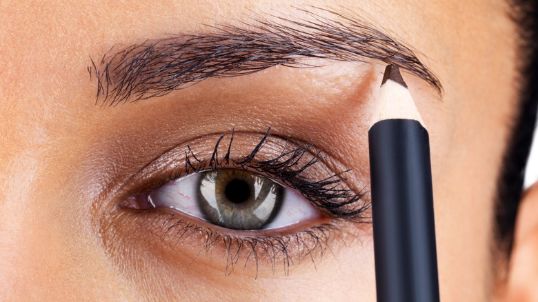 Close-up of eyebrow pencil being applied