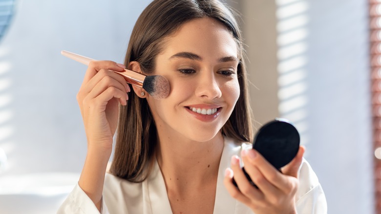 woman putting on highlighter