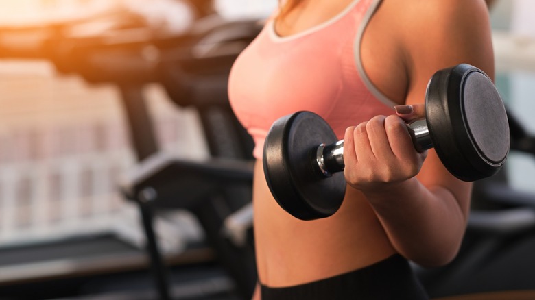 Woman holding dumbell weight