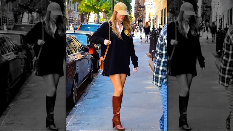 Taylor Swift walking in New York in 2023, wearing a cap, long rugby shirt, and knee high boots