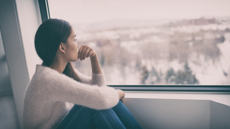 Woman alone by window