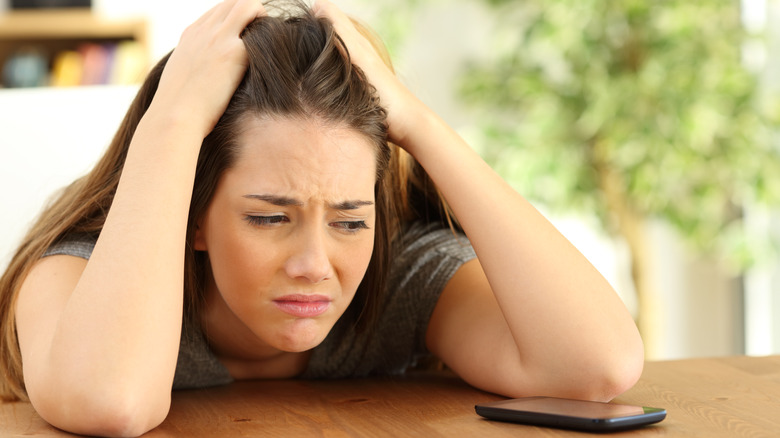 Anxious woman on her phone