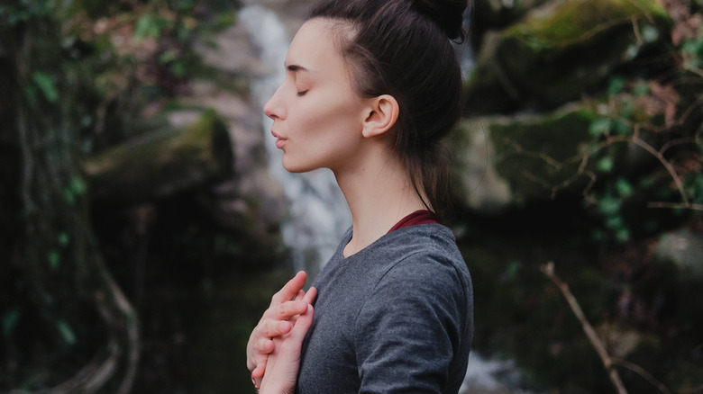 woman breathing hands chest