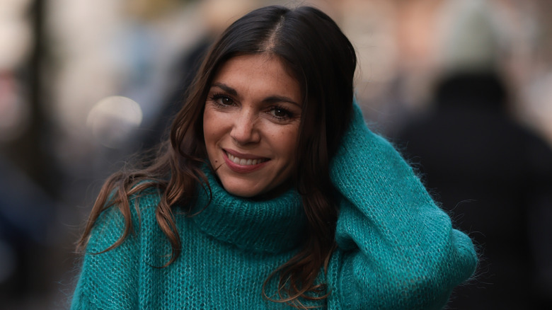 Woman in a green sweater smiling