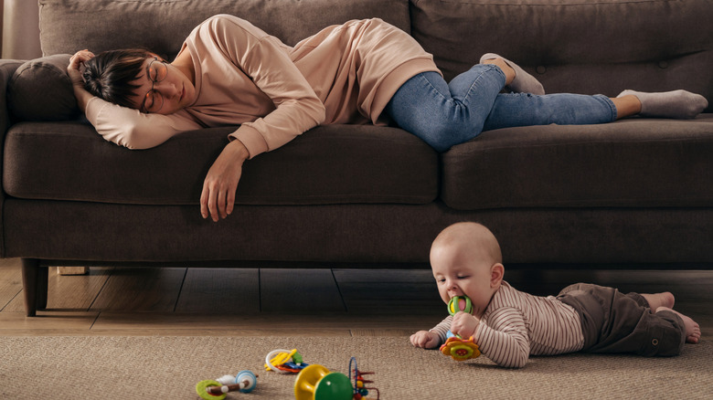 Mom sleeping, baby plays