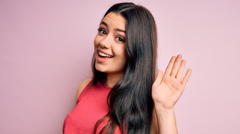 Woman waving goodbye