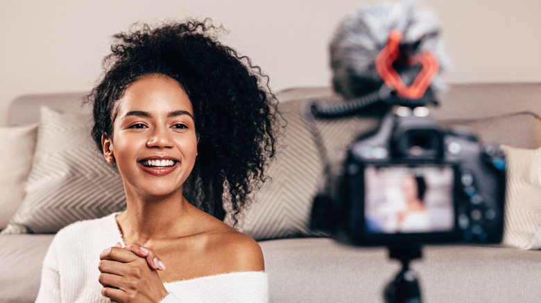 woman recording herself smiling