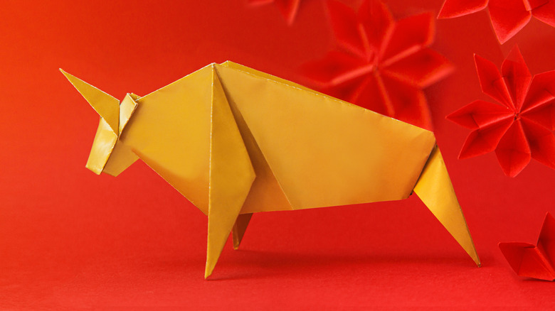 Origami animal in front of red background