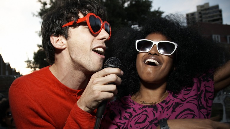 A man and woman singing together