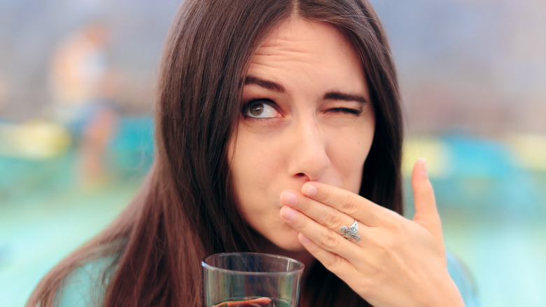 Young woman having hiccups