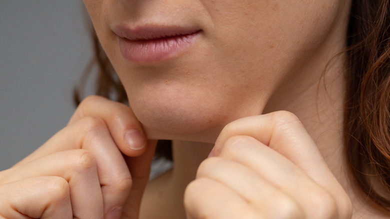 Pulling loose skin under the chin