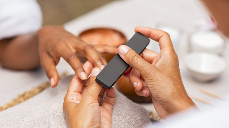 Woman getting manicure 