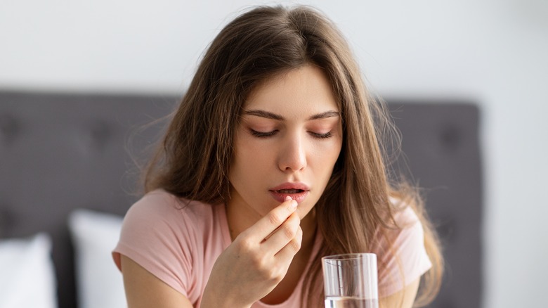 woman taking pill