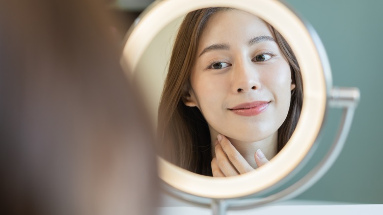 woman looking in mirror