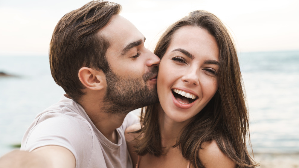 Smiling couple by the beach