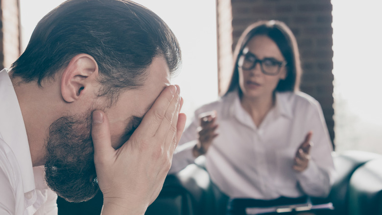 Woman speaking to visually upset man