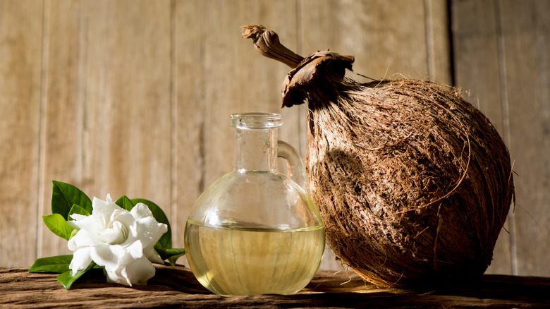 jar of oil, flower and coconut