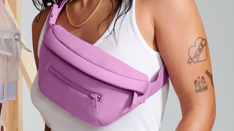 Person wearing purple crossbody fanny pack