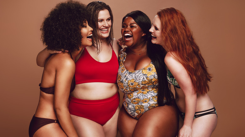 Women wearing bathing suits and laughing