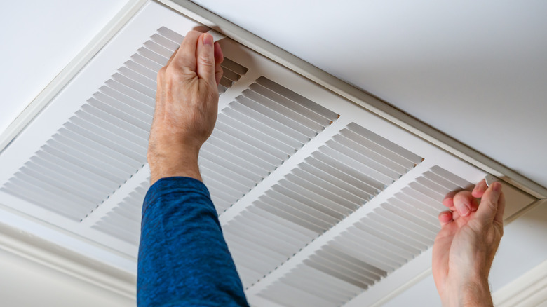 Man opening an air vent