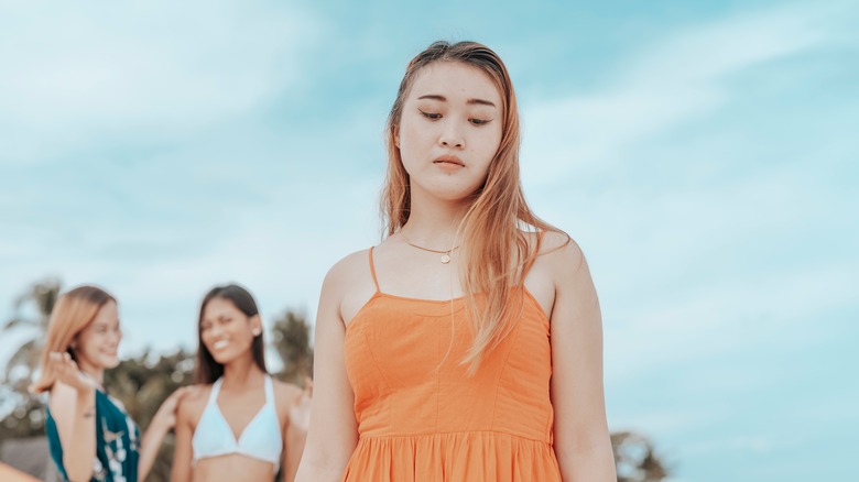 woman feeling sad with friends