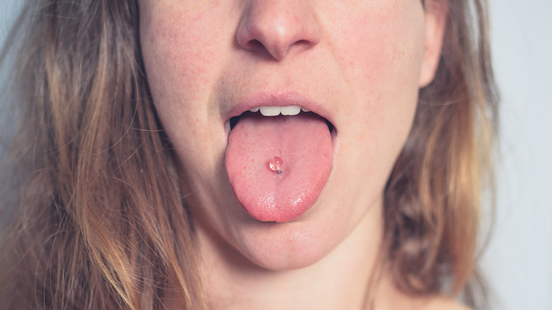 Woman with tongue piercing 