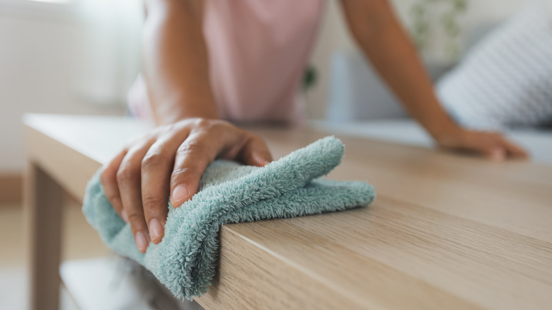 Woman cleaning table 