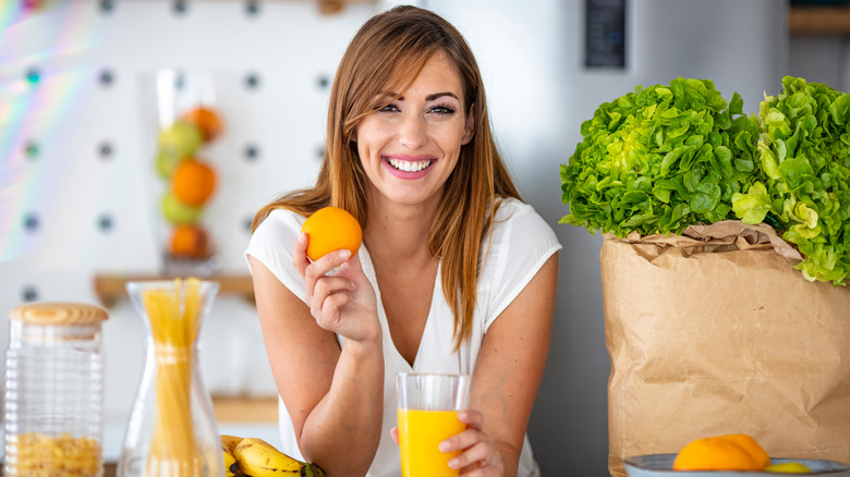 A women holding orange juice