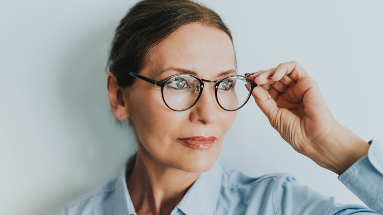 Woman with glasses and her hair pulled back